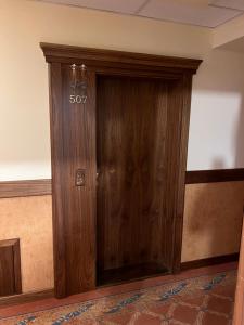a wooden door with a sign on it in a room at Havasi View Donovaly - 2 Bedrooms, Mountain View, Garage, 2 WC, Balcony, Dishwasher, Guitar, 164 cm TV, Netflix in Donovaly
