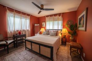 a bedroom with a bed and a ceiling fan at Stylized Captain's House in Captain Cook