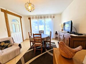 a living room with a dining room table and a tv at Charmante maison de vacances à Chauffayer - 4 pers - Aubessagne - FR-1-393-184 in Chauffayer