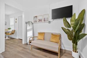 a living room with a couch and a tv on a wall at Affordable Private Studio in Pensacola