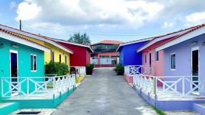 a row of colorful houses in a street at Guest Favorite - Central - Gated - 2 Bedrooms in Willemstad