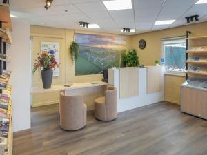 an office with stools and a large painting on the wall at Detached Holiday Home in Reevallis in Vijlen