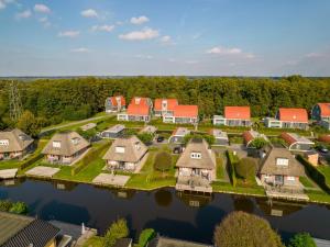 an aerial view of a home on the water at Scenic Holiday Chalet in Drenthe in Midlaren