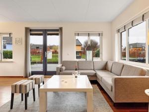 a living room with a couch and a table at Comfortable Waterfront Park Retreat in Midlaren