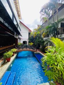 a pool in the middle of a building with plants at Nirvana Beach Resort in Boracay