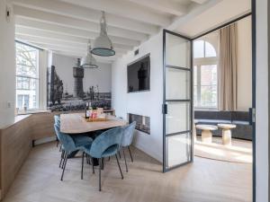 a kitchen and dining room with a table and chairs at Renovated luxury water tower within walking distance of the beach boulevard in Vlissingen +55 photos