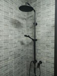 a shower with a shower head in a bathroom at Udon Thai House Resort & Hotel in Udon Thani