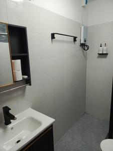 a white bathroom with a sink and a mirror at Udon Thai House Resort & Hotel in Udon Thani +30 photos