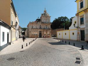 an empty street with a building in the background at The Sunny Cottage by Freetimealgarve in Faro