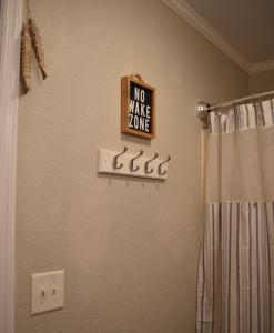 a bathroom with a no wake zone sign on the wall at Rustic River Cabin in Branford +44 photos