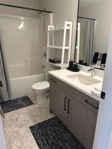 a bathroom with a sink and a toilet and a shower at Modern One-Bedroom Retreat in Bear Mountain in Langford