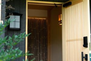 a front door of a house with a gate at なか富士 -Nakafuji- in Fujinomiya