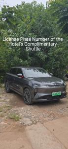 a black car parked on a dirt road at 头等舱国际酒店-成都天府机场店 in Jianyang