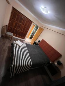 a bedroom with a large bed and a window at Lindo departamento pleno centro. in San Fernando del Valle de Catamarca