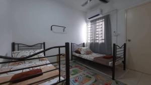 two bunk beds in a room with a window at Cozy Homey in Pancur