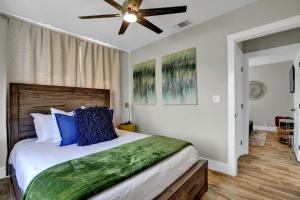 a bedroom with a large bed with blue pillows at Chateau De Callis - Hot Tub & 1 Block to Main St in Fredericksburg