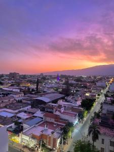 a view of a city at sunset at Lindo departamento pleno centro. in San Fernando del Valle de Catamarca