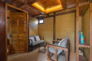 a living room with a couch and a chair at Opatan Art Villa - Sukawati, Gianyar, Bali in Sukawati