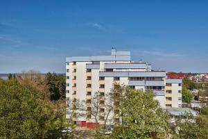 a tall white building with a cross on top of it at Terrassenhaus - 9 in Cuxhaven