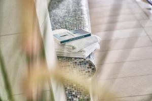 a book sitting on a chair with towels at Terrassenhaus - 9 in Cuxhaven