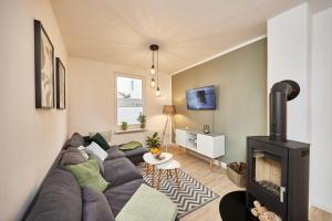 a living room with a couch and a fireplace at Heimathafen in Cuxhaven