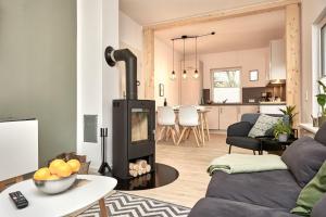 a living room with a wood stove in a room at Heimathafen in Cuxhaven +23 photos