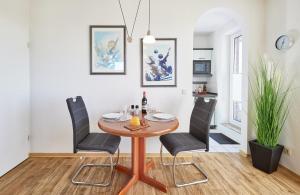 a dining room with a table and chairs at Knechtsand - 441 in Cuxhaven