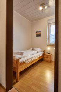 a bedroom with a bed and a window at Rotesand - 117 in Cuxhaven +14 photos