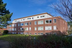 a red brick building with a lot of windows at Rotesand - 117 in Cuxhaven