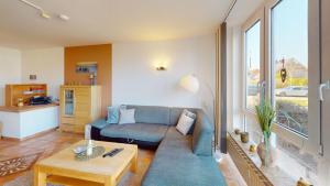 a living room with a couch and a table at Knechtsand - 403 in Cuxhaven