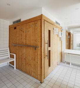 a wooden wall in a bathroom with a bench at Strandhochhaus Sahlenburg F1 in Cuxhaven