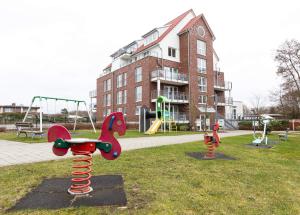 a park with playground equipment in front of a building at Hohe Lith - 335 in Cuxhaven