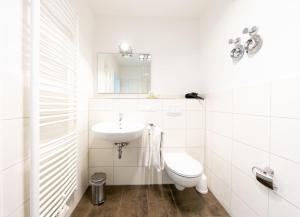 a white bathroom with a sink and a toilet at Hohe Lith - 335 in Cuxhaven +31 photos