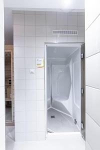 an empty refrigerator in a white tiled room at Hohe Lith - 335 in Cuxhaven