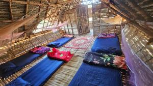a group of pillows and blankets in a room at Time Travellers Hostel in Auroville +122 photos