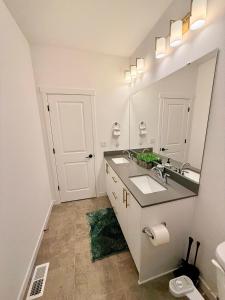 a bathroom with a sink and a mirror at Cozy Retreat, Room 2, Near Mt Rainier, Seattle, National parks in Bonney Lake
