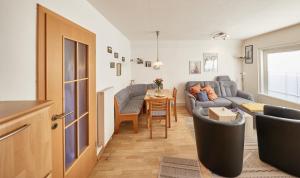 a living room with a couch and a table at Haus Tide in Cuxhaven