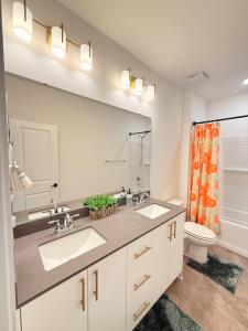 a bathroom with two sinks and a toilet at Cozy Retreat, Room 2, Near Mt Rainier, Seattle, National parks in Bonney Lake