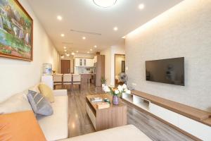 a living room with a large flat screen tv on a wall at Duc Hoang Residence & Hotel West Lake in Hanoi