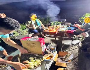 a group of people sitting around a grill with a box at Kura "Ika" - Vacation STAY 95263v in Nagahama