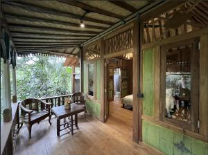 a room with a table and chairs in a house at The Manikyang Residence in Tabanan
