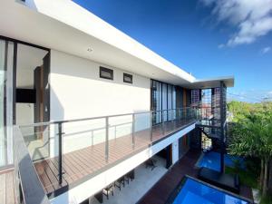 a balcony with a view of a house at Shinta Villa 2 Uluwatu in Jimbaran