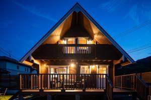 a house with a gambrel roof with a balcony at Villa & Sauna - NAGIOTO - in Kure +40 photos
