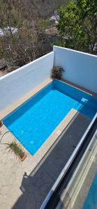 a swimming pool with blue water in a backyard at House with a View and Private Pool in Santa Cruz Huatulco