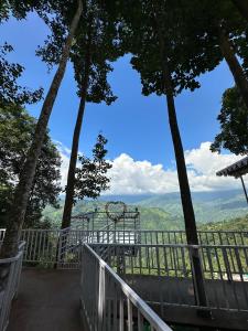 a balcony with a view of the mountains at Sukhim Farmstay in Mirik
