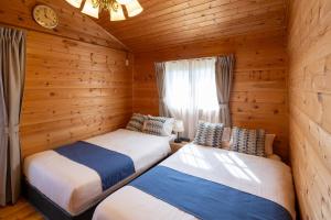 Postel nebo postele na pokoji v ubytování Villa & Sauna - NAGIOTO -