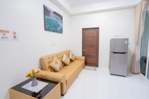 a living room with a couch and a refrigerator at SeaEagle Cozy House Villa Aonang in Ao Nang 