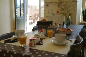 a table with breakfast foods and drinks on it at La maison d'hôtes Ty Pic in La Vicomté-sur-Rance +43 photos