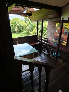 a porch of a house with a table and a window at Boon Homestay & Cafe บุญโฮมสเตย์ in Ban Buak Khang +76 photos