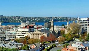 a view of a city with a river and buildings at Travel Stay Centre City Hostel in Dunedin